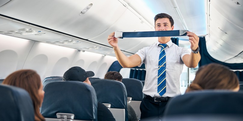 Flight attendant giving safety instructions