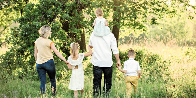 Family of five walking in the forest